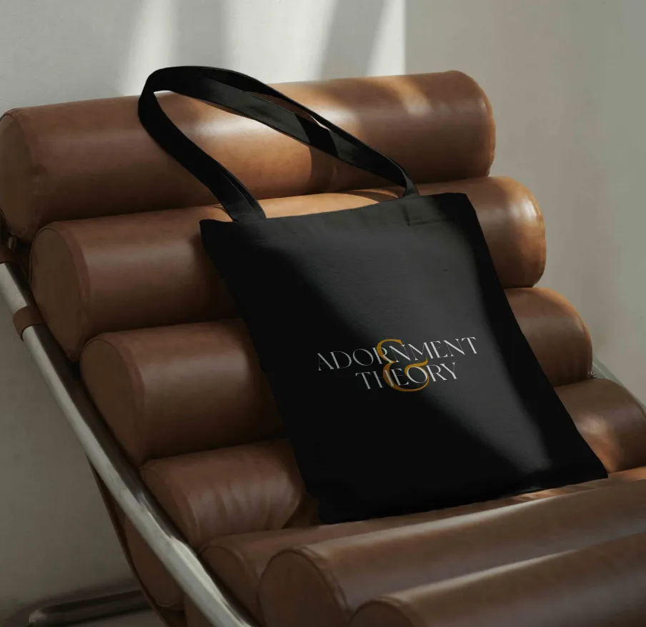 Mockup of Adornment + Theory logo on a tote bag